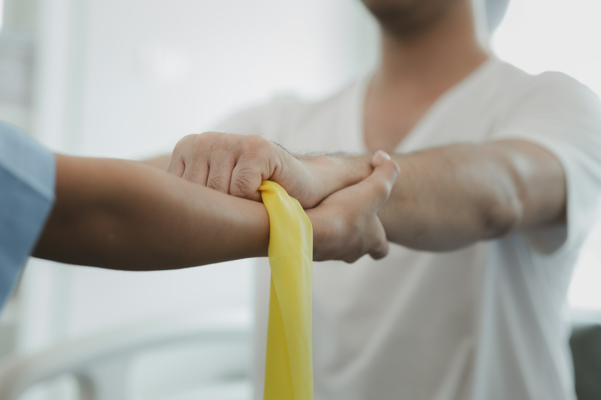 Physiotherapist is doing physical therapy for a patient, the patient has body aches due to overwork. Melanie Holden Offered Services